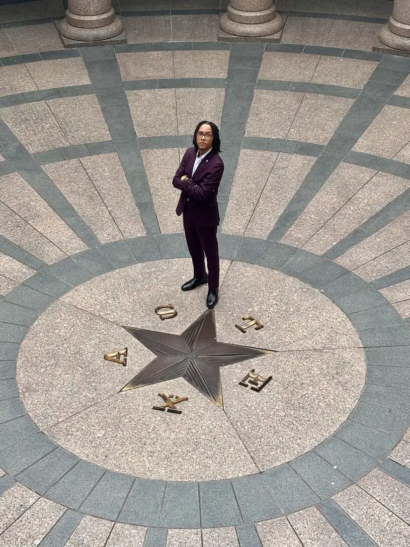 Nicholas Hawkins standing at the center of the Texas Capitol rotunda.