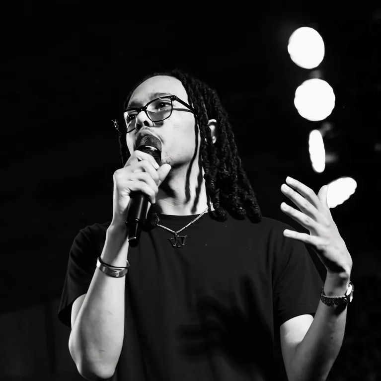 Nicholas Hawkins addressing a crowd, microphone in hand.